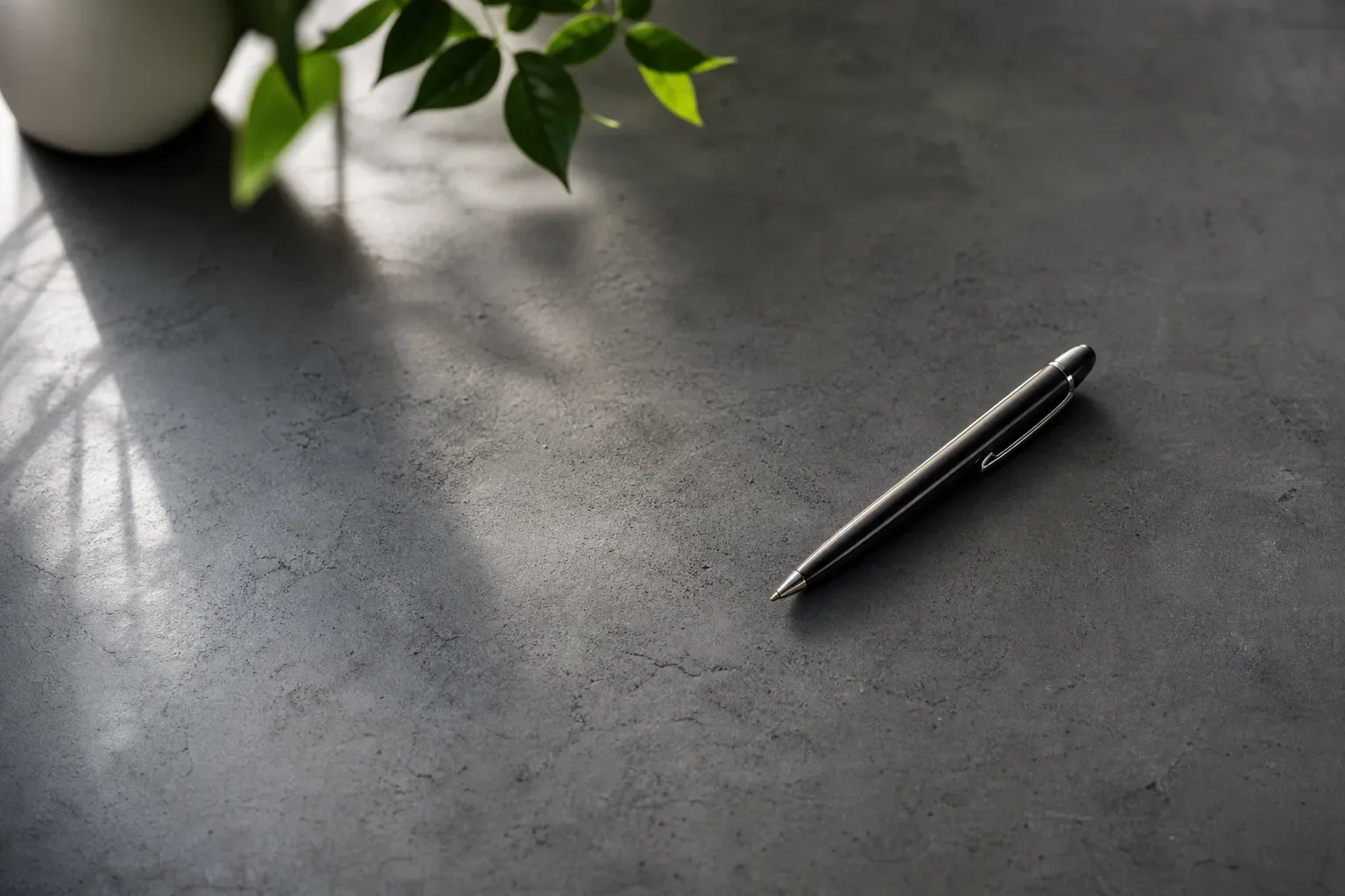 A pen resting on a work surface