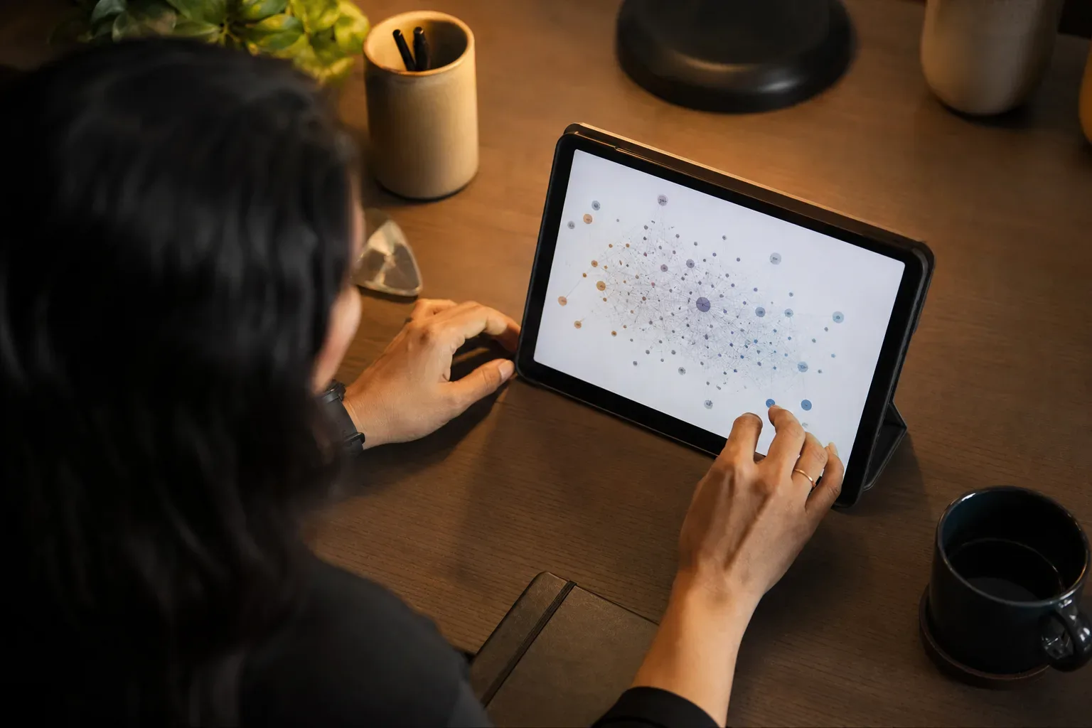 A tablet propped upright showing an abstract unreadable data visualisation